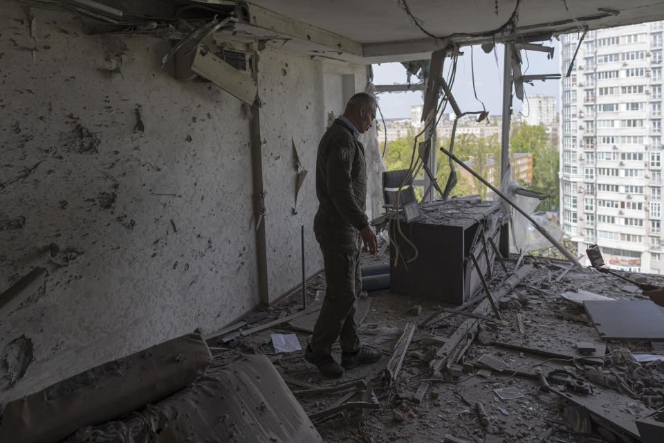 Kyiv Mayor Vitali Klitschko reacts standing in an apartment building damaged by a drone that was shot down during a Russian overnight strike, amid Russia's attack, in Kyiv, Ukraine, Monday, May 8, 2023. (AP Photo/Andrew Kravchenko)