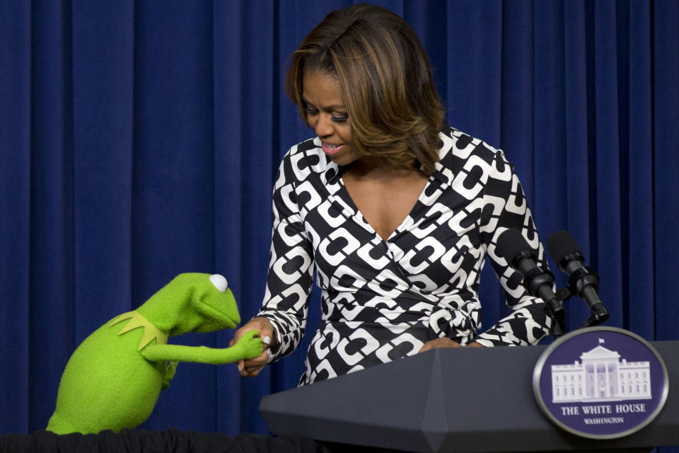 Kermit the Frog kisses the hand of first lady Michelle Obama, during an event for children in military families in the South Court Auditorium of the Eisenhower Executive Office Building on the White House complex, Wednesday, March 12, 2014, before a screening of Disney’s "Muppets Most Wanted" movie as part of the Joining Forces initiative. (AP Photo/Jacquelyn Martin)