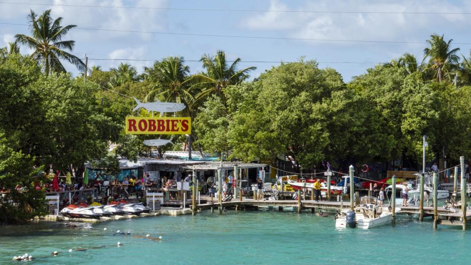 <p>Don't miss these food finds along the Overseas Highway—the southernmost leg of U.S. Route 1—one of the most scenic drives in the country. </p> <p>At <a href="https://www.pilothousemarina.com/" rel="nofollow noopener" target="_blank" data-ylk="slk:Pilot House;elm:context_link;itc:0;sec:content-canvas" class="link ">Pilot House</a>, a local hangout in Key Largo, guests can enjoy jerk fish tacos while watching fish swim at the glass bottom bar.</p> <p><a href="https://www.robbies.com/" rel="nofollow noopener" target="_blank" data-ylk="slk:Robbie's of Islamorada;elm:context_link;itc:0;sec:content-canvas" class="link ">Robbie's of Islamorada</a>, a Florida Keys rite of passage where tourists flock to feed tarpon off the dock, boasts the Hungry Tarpon restaurant where you can get a massive (and delicious!) breakfast burrito for less than $10. </p> <p>At <a href="http://burdineswaterfront.com/" rel="nofollow noopener" target="_blank" data-ylk="slk:Burdines Waterfront;elm:context_link;itc:0;sec:content-canvas" class="link ">Burdines Waterfront</a> in Marathon, chilled key lime wrapped in a flour tortilla, then deep-fried and dusted in cinnamon sugar is the star of the show. </p> <p>Finally, make sure to stop on Stock Island at <a href="http://www.roostica.com/" rel="nofollow noopener" target="_blank" data-ylk="slk:Roostica;elm:context_link;itc:0;sec:content-canvas" class="link ">Roostica</a> for the best pizza in the Keys. If you like heat, try the Hell's Kitchen Diavola pie with spicy salami and lots of garlic.</p>