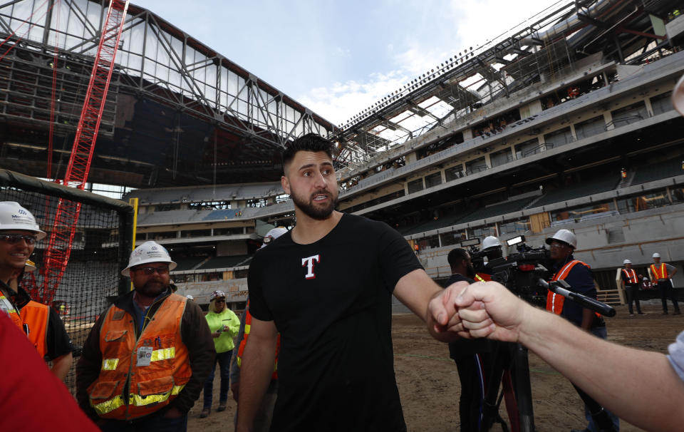 Texas Rangers Joey Gallo is greeted after a batting practice at the under construction baseball field at the new Rangers stadium in Arlington, Texas, Wednesday, Dec. 4, 2019. (AP Photo/LM Otero)