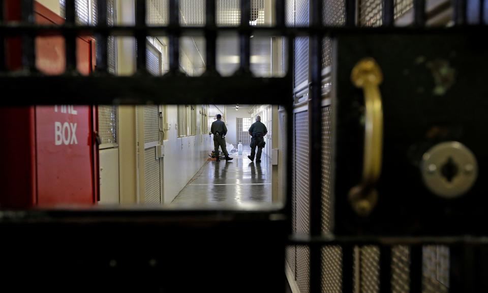 Guards walk a corridor in the death row adjustment center at San Quentin State Prison in San Quentin, California.