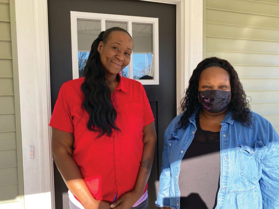 Ilena Lee, left, stands outside of her home with Barbara Hunter-Geer, a case manager for United Housing Connections. Lee and her children had been sleeping on friends' couches for five months when they found help from UHC.