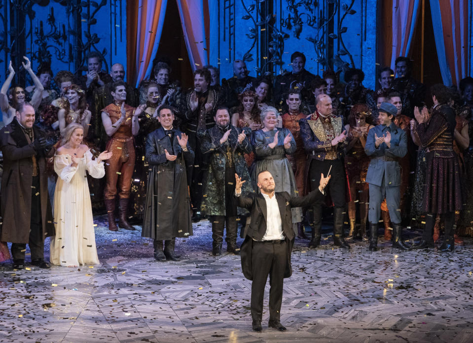 In this Dec. 4, 2018 photo released by the Metropolitan Opera, conductor Yannick Nézet-Séguin acknowledges the crowd at a curtain call following the new production premiere of Verdi's "La Traviata," at the Metropolitan Opera in New York. (Jonathan Tichler/Metropolitan Opera via AP)