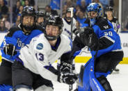 Toronto goaltender Kristen Campbell (50) keeps an eye on the play as Toronto's Kali Flanagan (6) defends against Minnesota's Grace Zumwinkle (13) during the second period of Game 1 of a PWHL hockey playoffs semifinal Wednesday, May 8, 2024, in Toronto. (Frank Gunn/The Canadian Press via AP)