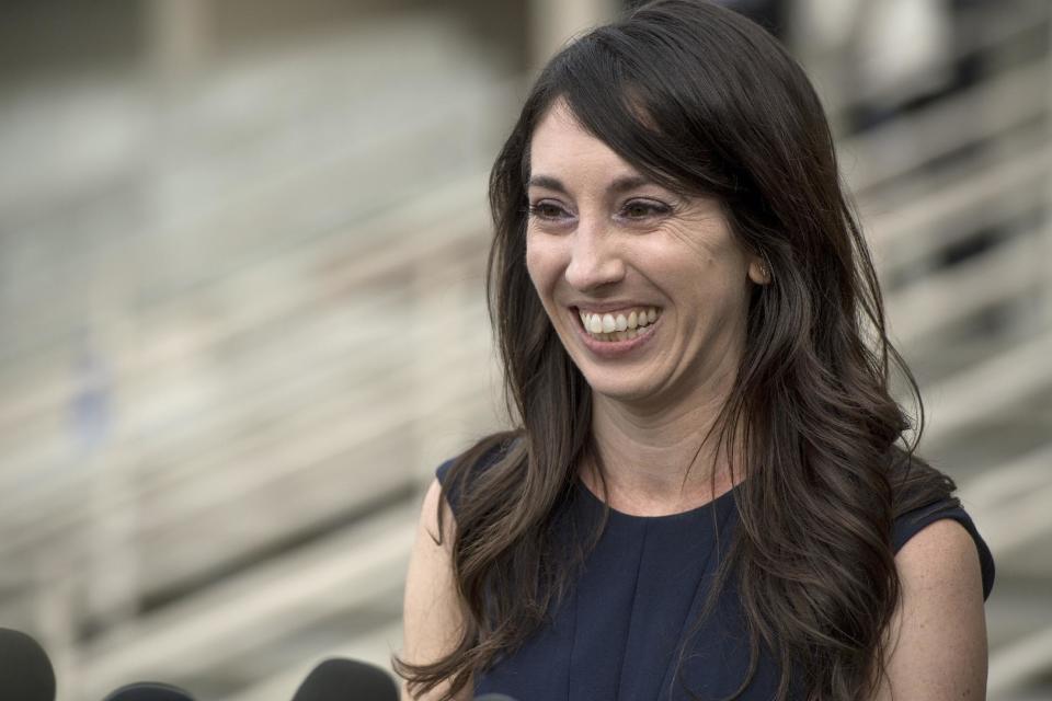 Michelle Susan Hadley addresses the media after being cleared of all charges in a plot to frame her, after coming out of court in Fullerton, Calif., Monday, Jan. 9, 2017. Hadley has been exonerated of charges that she placed "rape fantasy" ads on Craigslist in order to get men to attack her ex-boyfriend's new wife. Prosecutors now say that it was the alleged victim in the case who was trying to frame her husband's ex by placing the malicious ads. (Jeff Gritchen/The Orange County Register via AP)