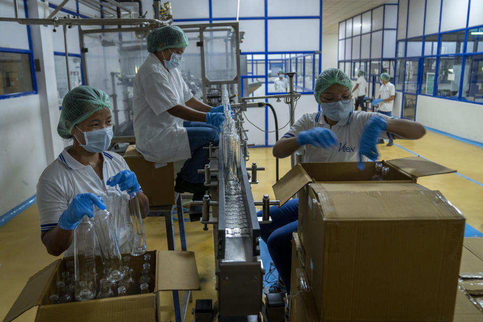 Women work inside the Veen Waters bottling plant near Samtse, Bhutan, Wednesday, May 10, 2023. The company employs more than 40 people in Bhutan, who help bottle natural mineral water from a nearby spring. The bottled water is trucked to India, where Veen is based. (AP Photo/Dar Yasin)