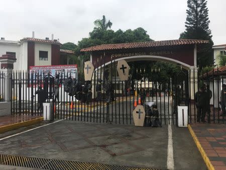 Dummies simulating corpses and cardboard coffins are seen hanging at the gates of the Venezuelan National Guard headquarters during a protest of opposition lawmakers in Caracas, Venezuela June 20, 2017. Prensa PJ Diputados/Handout via REUTERS