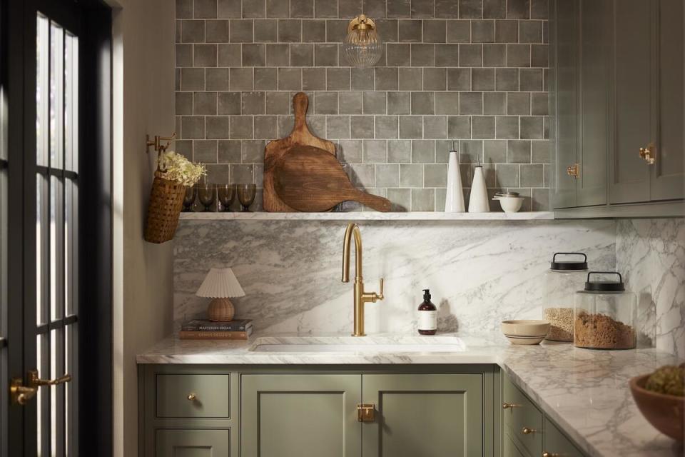 The Edalyn pull-down faucet and Embra sconce by Shea McGee for Kohler and Canyon Lake tile by Shea McGee for Ann Sacks