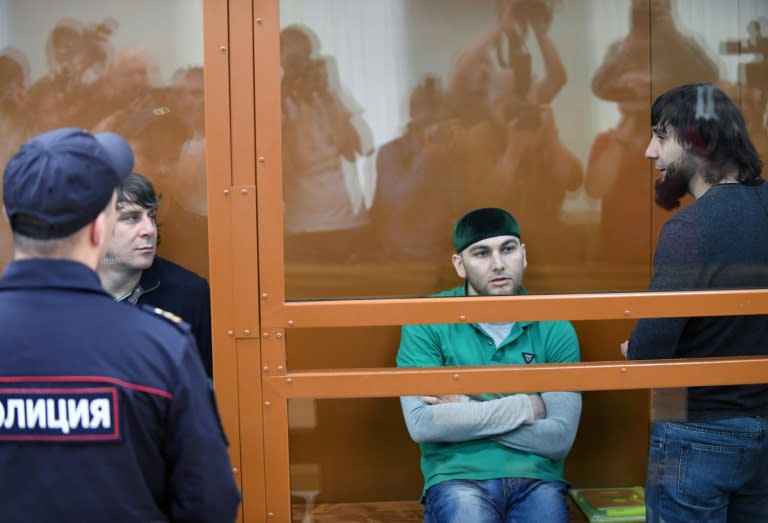 (L-R) Temirlan Eskerkhanov, Shadid Gubashev and Zaur Dadayev, three of five men charged with carrying out the assassination of Boris Nemtsov, seen in a defendants' cage during a hearing at the Moscow District Military Court on June 27, 2017