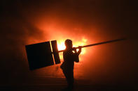 <p>Supporters of Honduran presidential candidate for the Opposition Alliance against the Dictatorship party Salvador Nasralla, set a barricade alight during a protest outside the Electoral Supreme Court (TSE), to demand the announcement of the election final results in Tegucigalpa, on Nov. 30, 2017. (Photo: Orlando Sierra/AFP/Getty Images) </p>