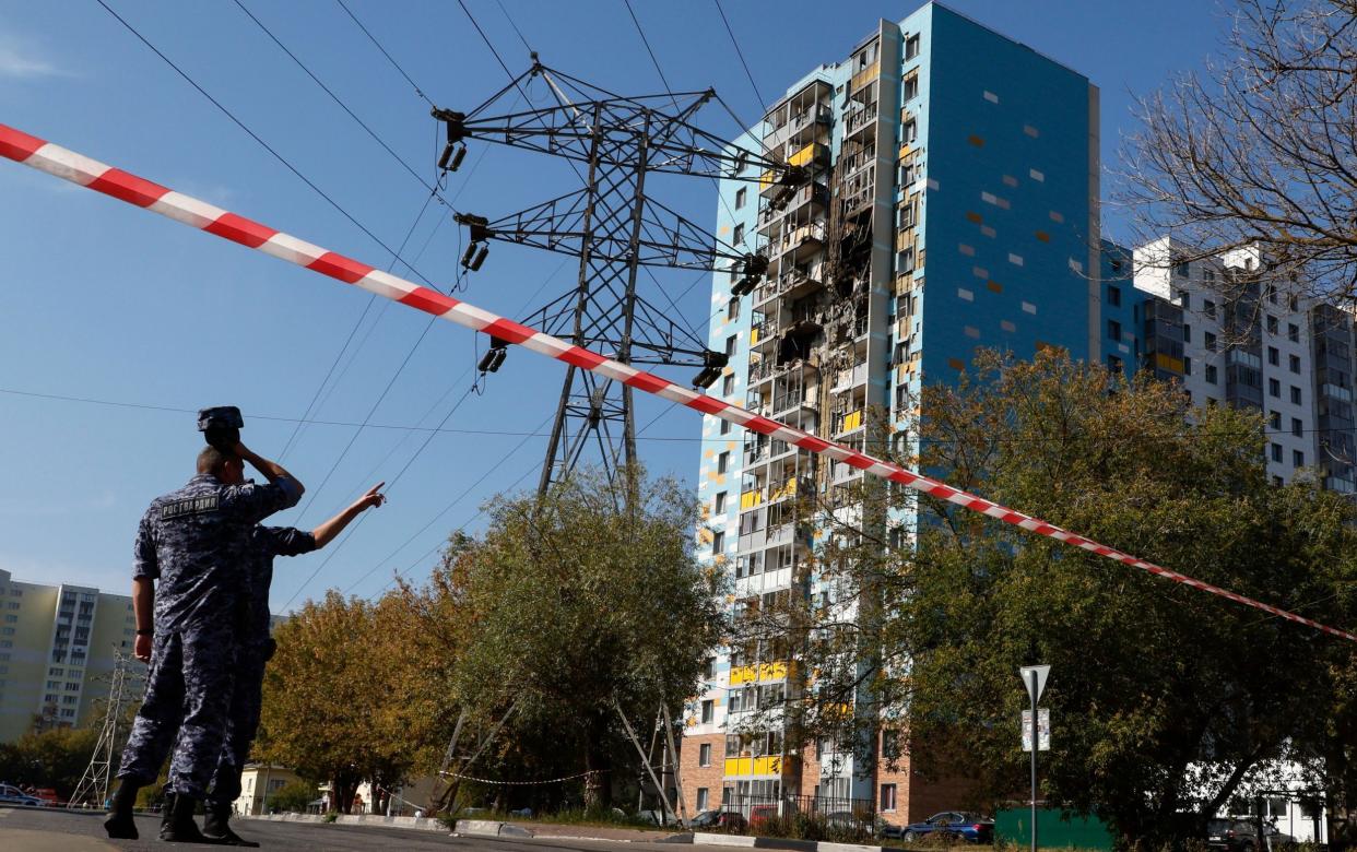 Russian police at the damaged apartment building in Ramensky following the Ukrainian drone attack