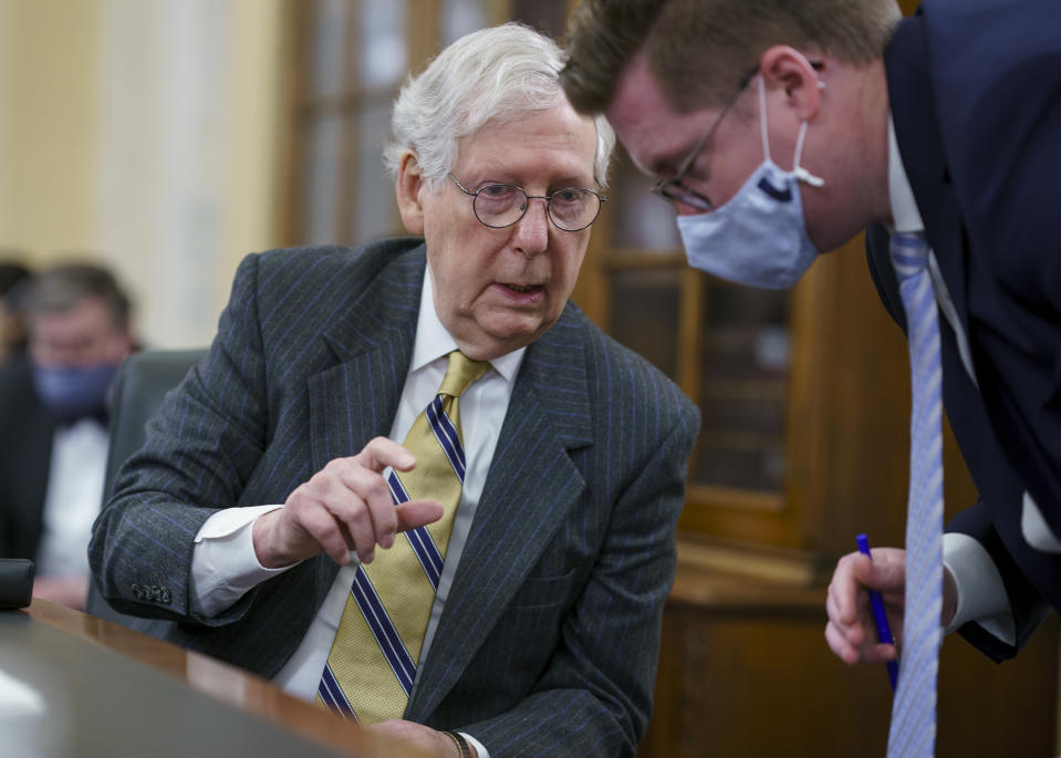 Senate Minority Leader Mitch McConnell, R-Ky., turns to an aide as the Senate Rules Committee holds a hearing on the "For the People Act," which would expand access to voting and other voting reforms, at the Capitol in Washington, Wednesday, March 24, 2021. The bill has already passed in the House. (AP Photo/J. Scott Applewhite)