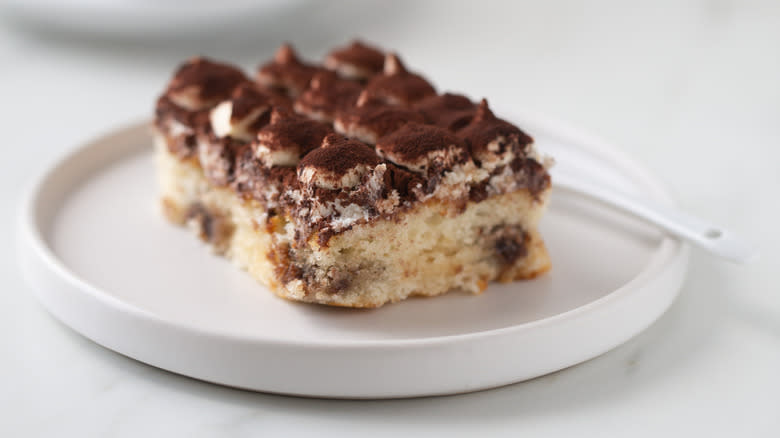 Moist slice of chocolate cake on a white plate