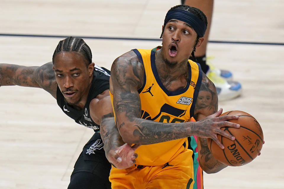 San Antonio Spurs forward DeMar DeRozan, left, guards Utah Jazz guard Jordan Clarkson, right, in the first half during an NBA basketball game Monday, May 3, 2021, in Salt Lake City. (AP Photo/Rick Bowmer)