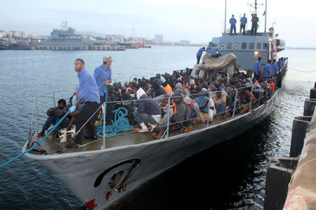 Migrants arrive by boat at a naval base after they were rescued by Libyan coastguard, in the coastal city of Tripoli, Libya, May 26, 2017. REUTERS/Hani Amara