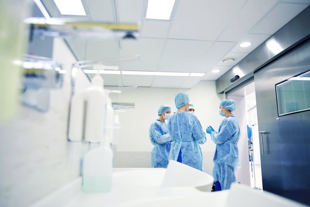 A group of surgeons in an operating room at a hospital talk and prepare to operate in this file photo. (Shutterstock - image credit)