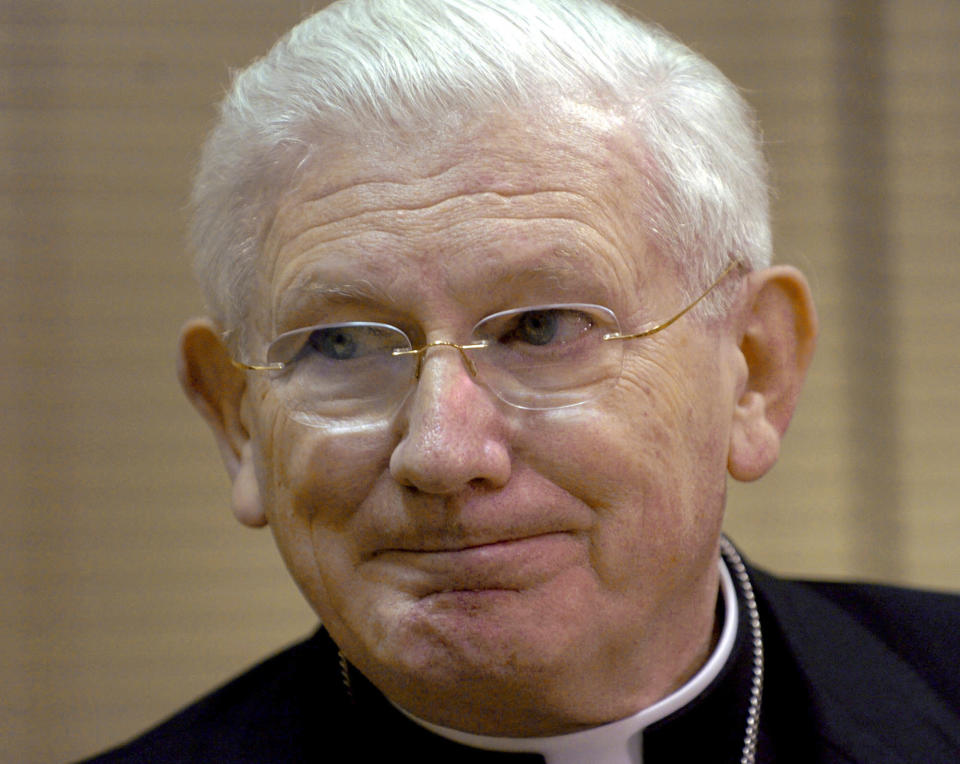 FILE - In this Saturday, April 2, 2005, file photo, Baltimore Cardinal William Keeler speaks to reporters before conducting Mass at The Cathedral of Mary Our Queen, in Baltimore. A new Catholic school in Baltimore will no longer feature the name of a late cardinal accused of failing to act in the case of priests who abused children in Pennsylvania. Cardinal William H. Keeler had a reputation for transparency as archbishop of Baltimore, releasing in 2002 the names of 57 priests accused of sexual abuse. But a grand jury report released Tuesday, Aug. 14, 2018, details widespread sexual abuse in six of Pennsylvania's Roman Catholic dioceses and accuses Keeler of covering up sexual abuse allegations while serving as bishop of Harrisburg. (AP Photo/Gail Burton, File)