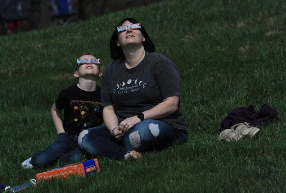 Kylie Wyer, right, and Brendan Wyer, 10, both of Junction City, view the solar eclipse at its totality at The Dawes Arboretum on Monday, April 8, 2024.