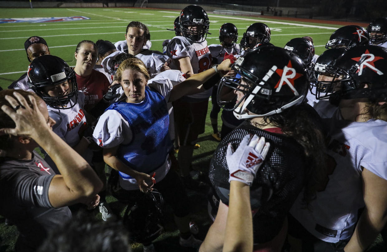Revere - July 15: The Boston Renegades women's football team comes in for a huddle at the conclusion of the teams practice at the Harry della Russo Stadium in Revere, MA on Thursday night, July 15, 2021. The women's football team has qualified for the national championship game in Ohio and is aiming for a third straight title. (Photo by Erin Clark/The Boston Globe via Getty Images)