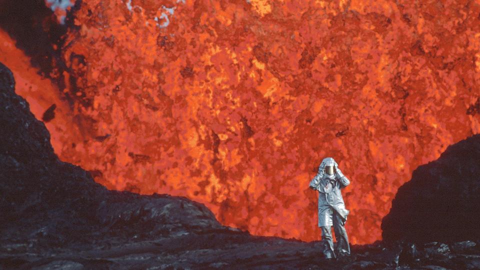 Katia Krafft stands near a volcano