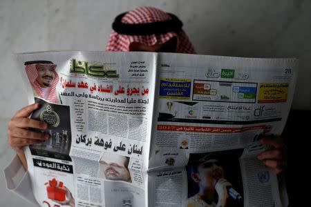 A man reads a newspaper in Riyadh, Saudi Arabia, November 5, 2017. REUTERS/Faisal Al Nasser