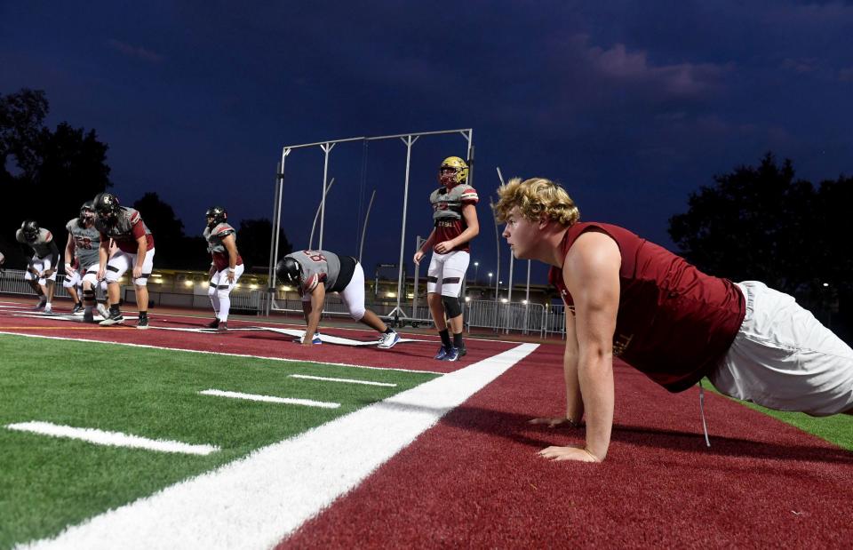 Offensive lineman Luke Baklenko does some doing push-ups during an Oaks Christian football team practice on Tuesday, Oct. 11, 2022. The Lions, who are 5-2 overall and 1-0 in the Marmonte League, host rival Westlake on Friday night.