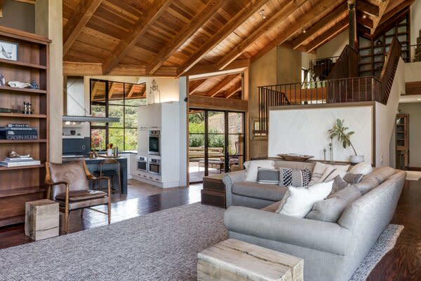 Vaulted wooden ceilings further enhances the grand sense of space throughout the main living areas on the first floor. Floor-to-ceiling windows ushers in ample natural light.