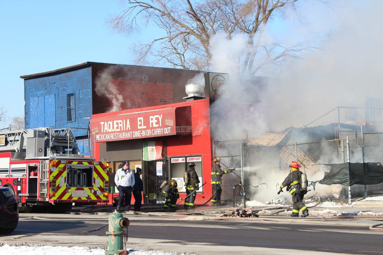 Firefighters work to put out the flames in Taqueria El Rey on the morning of Jan. 29.