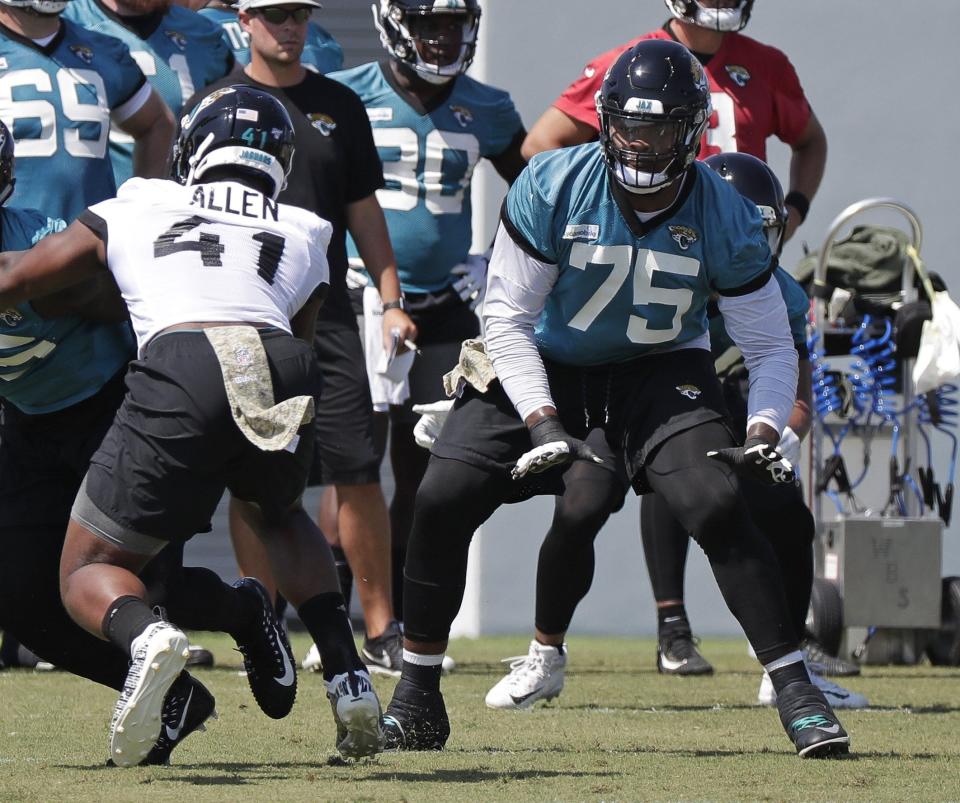 Jacksonville Jaguars offensive lineman Jawaan Taylor (75) looks to block Jacksonville Jaguars defensive end Josh Allen (41) during an NFL football practice, Tuesday, May 21, 2019, in Jacksonville, Fla. (AP Photo/John Raoux)