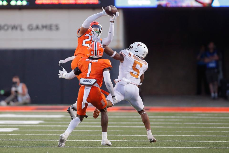 Oklahoma State Cowboys safety Jason Taylor II (25) intercepts a pass intended for Texas Longhorns running back Bijan Robinson (5) during a college football game between the Oklahoma State Cowboys (OSU) and the University of Texas Longhorns at Boone Pickens Stadium in Stillwater, Okla., Saturday, Oct. 22, 2022. Oklahoma State won 41-34.