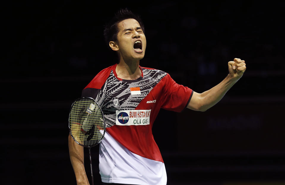 Simon Santoso of Indonesia celebrates after scoring a point against Lee Chong Wei of Malaysia during their men's singles final match at the Singapore Open Badminton championship on Sunday, April 13, 2014 in Singapore. Santoso won the match. (AP Photo/Wong Maye-E)