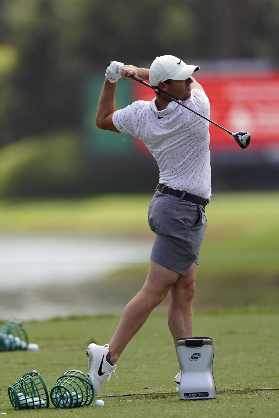 Rory McIlroy follows through on a shot the driving range during practice for the Tour Championship golf tournament at East Lake Golf Club Thursday, Sept. 3, 2020, in Atlanta. (AP Photo/John Bazemore)