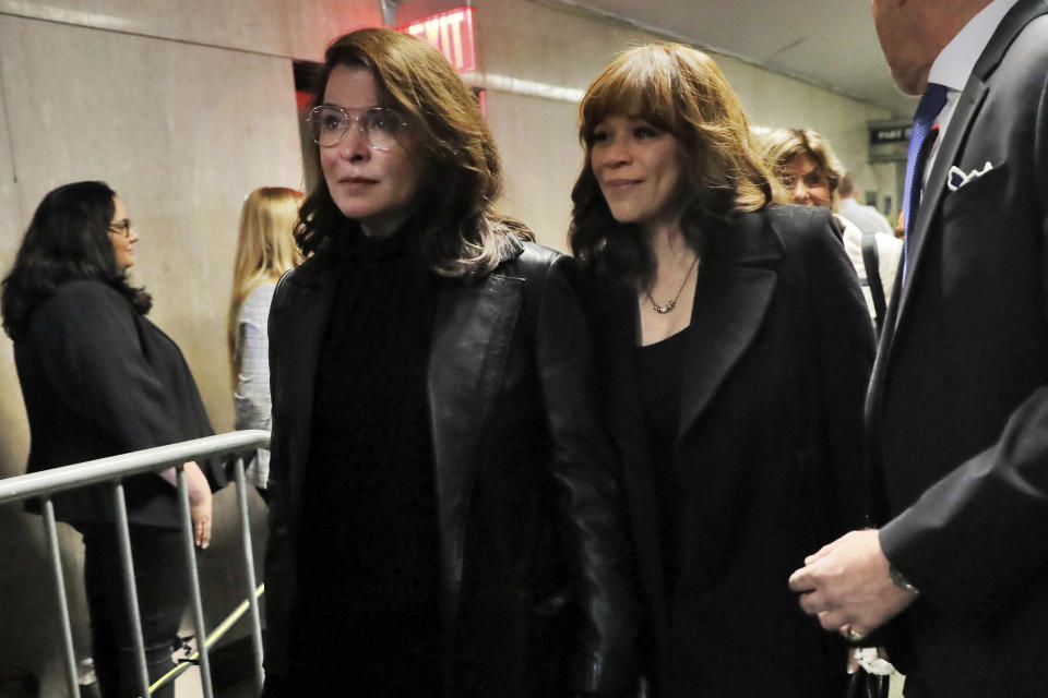 Annabella Sciorra, left, and Rosie Perez, leave court after the sentencing of Harvey Weinstein, in New York, Wednesday, March 11, 2020. (AP Photo/Richard Drew)