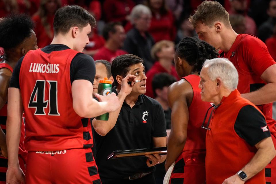 Cincinnati Bearcats head coach Wes Miller draws up strategy late in the game against Texas. UC led 73-70 with under a minute to go, but lost 74-73.