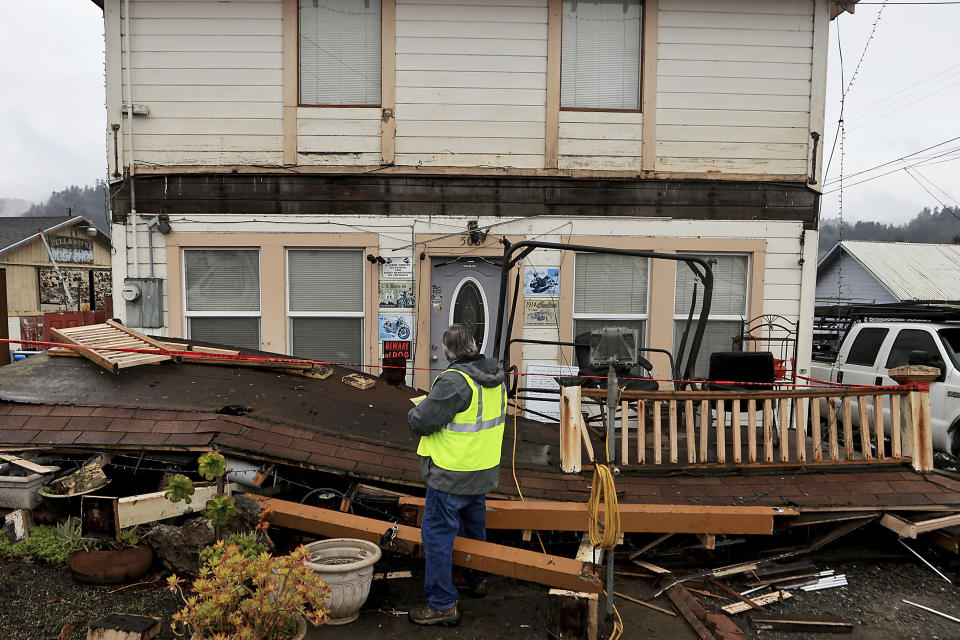 Building inspector Kevin Caldwell, red tags a home in Rio Dell, Calif., that lost an awning and deck, after an earthquake hit Humboldt County, Tuesday, Dec. 20, 2022. A powerful earthquake rocked a rural stretch of the Northern California coast early Tuesday, jolting residents awake, cutting off power to 70,000 people, and damaging some buildings and a roadway, officials said. (Kent Porter/The Press Democrat via AP)