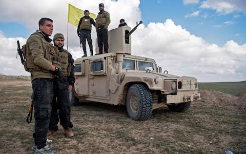 US-backed Syrian Democratic Forces (SDF) fighters gather as they prepare to expel hundreds of the Islamic State group (IS) jihadists from the Baghouz area in the eastern Syrian province of Deir Ezzor - Credit: AFP