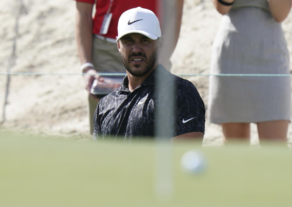 Brooks Koepka, of the United States, watches his third shot during the second round of the Hero World Challenge PGA Tour at the Albany Golf Club, in New Providence, Bahamas, Friday, Dec. 3, 2021.(AP Photo/Fernando Llano)