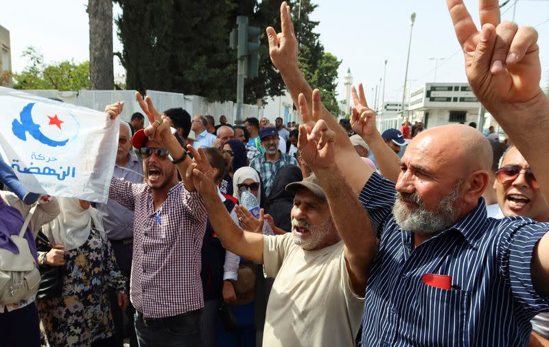 Supporters of Tunisia's Islamist opposition party Ennahda gesture as they protest in Tunis