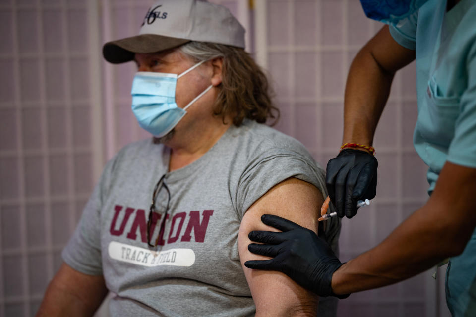 Jerald Bagley, 57, receives the Moderna coronavirus disease (COVID-19) booster vaccine targeting BA.4 and BA.5 Omicron sub variants at Skippack Pharmacy in Schwenksville, Pennsylvania, U.S., September 8, 2022.  REUTERS/Hannah Beier