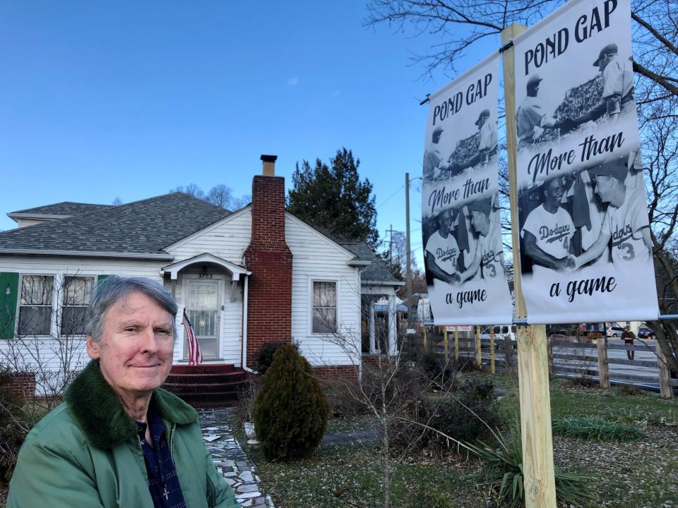 David Williams is shown on Jan. 25, 2022, at his Sutherland Avenue home next to one of the banners he erected to help local residents remember when the Pond Gap field was a place where Black players and white players competed.