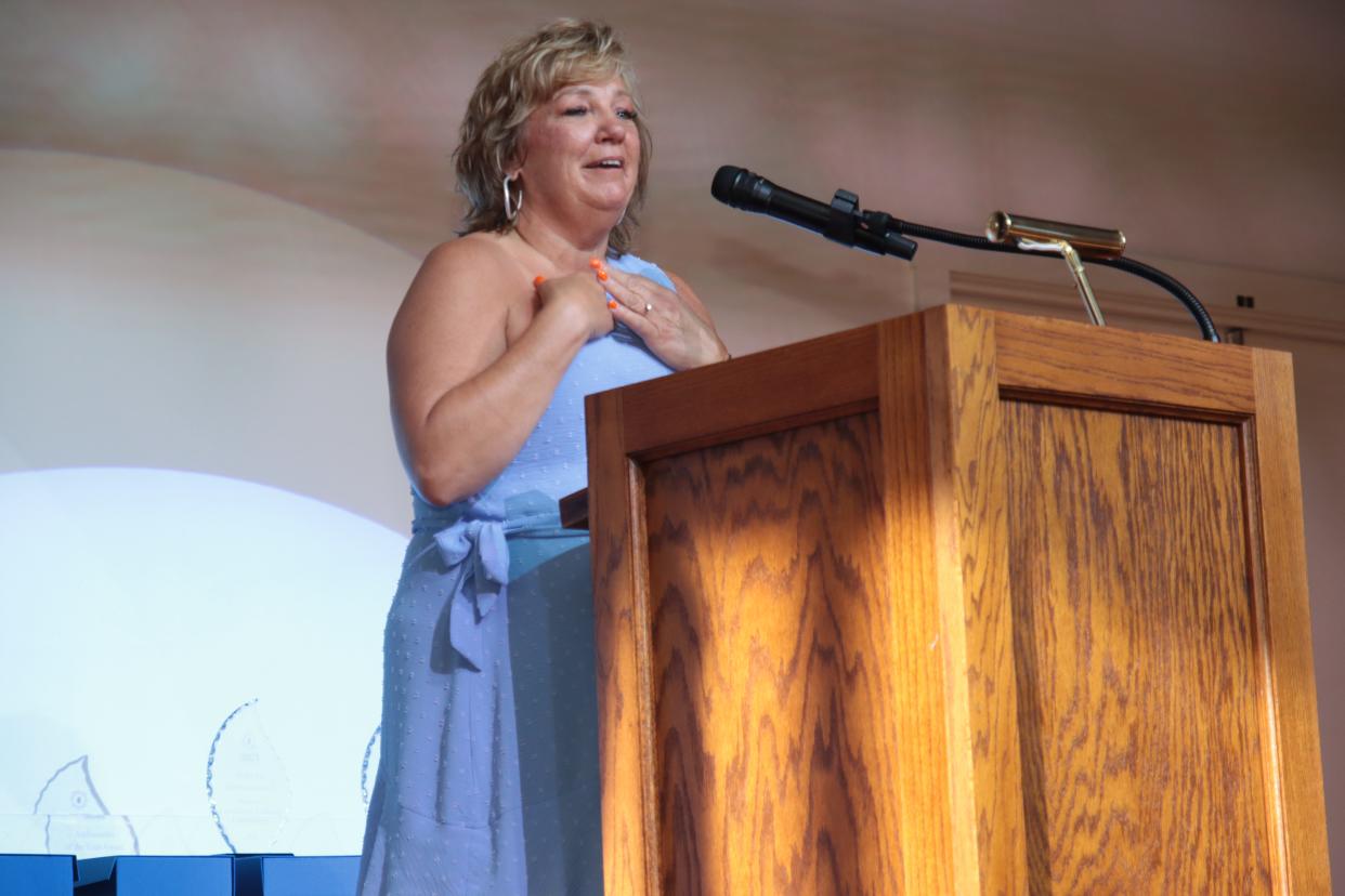 Janis Montalvo of Living in Lenawee Realty accepts the Growing Talent Award during the Greater Lenawee Chamber of Commerce's awards ceremony May 1 at the Adrian Armory Events Center.