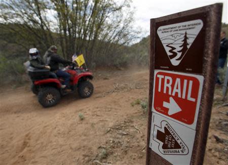 ATV riders ride past a trail sign in Recapture Canyon outside Blanding, Utah, May 10, 2014. REUTERS/Jim Urquhart