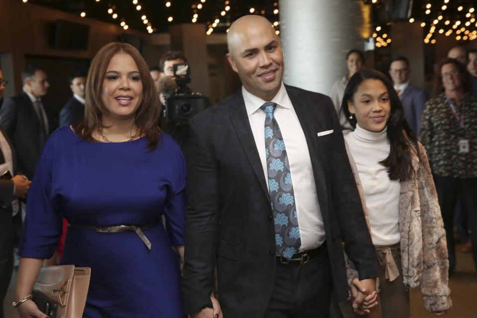 FILE - In this Nov. 4, 2019, file photo, New York Mets new manager Carlos Beltran arrives at an introductory baseball news conference with his family, including his wife Jessica Beltran, left, at Citi Field in New York. Beltran is out as manager of the Mets. The team announced the move Thursday, Jan. 16, 2020. (AP Photo/Seth Wenig, File)