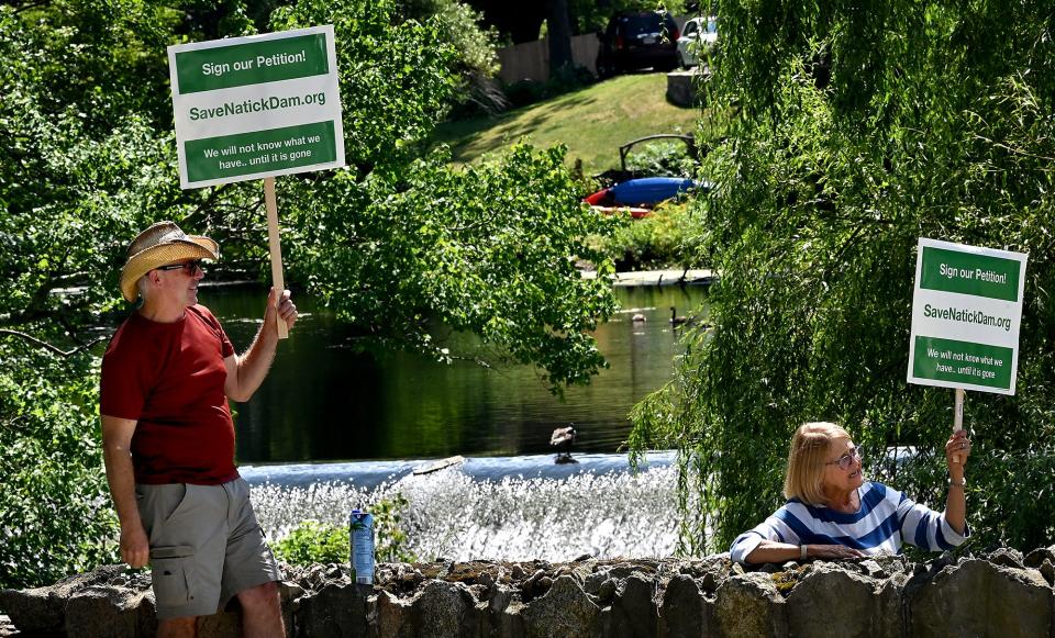 Some Natick residents, including Artie Doran, left, and Linda Curtis, expressed opposition to removal of the Charles River Dam in South Natick in July 2022, favoring that it instead be repaired.