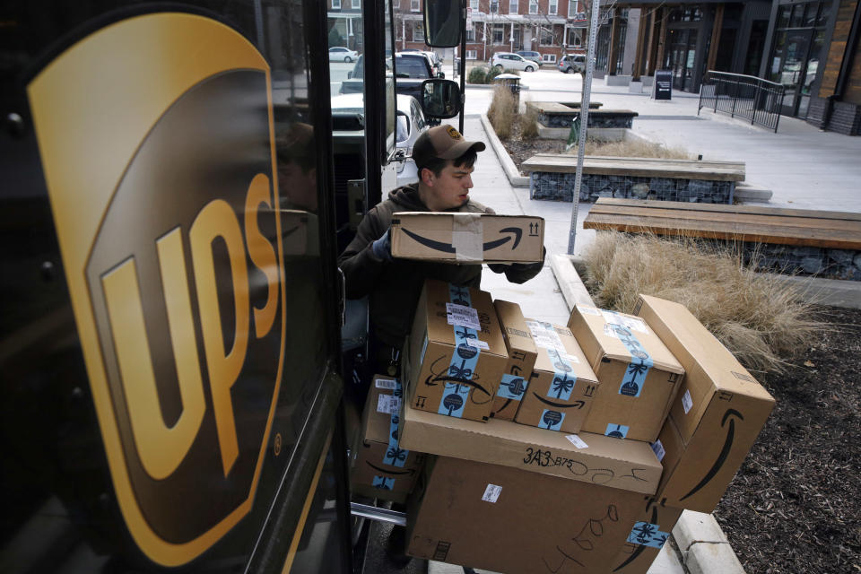 FILE- In this Dec. 19, 2018, file photo a UPS driver prepares to deliver packages. United Parcel Service Inc. reports financial results Thursday, Jan. 31, 2019. (AP Photo/Patrick Semansky, File)