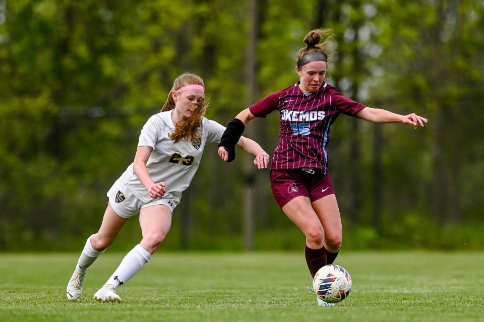Okemos' Allison Korb, right, moves the ball as DeWitt's Ava Mardigian closes in during the first half on Tuesday, May 16, 2023, at Okemos High School.