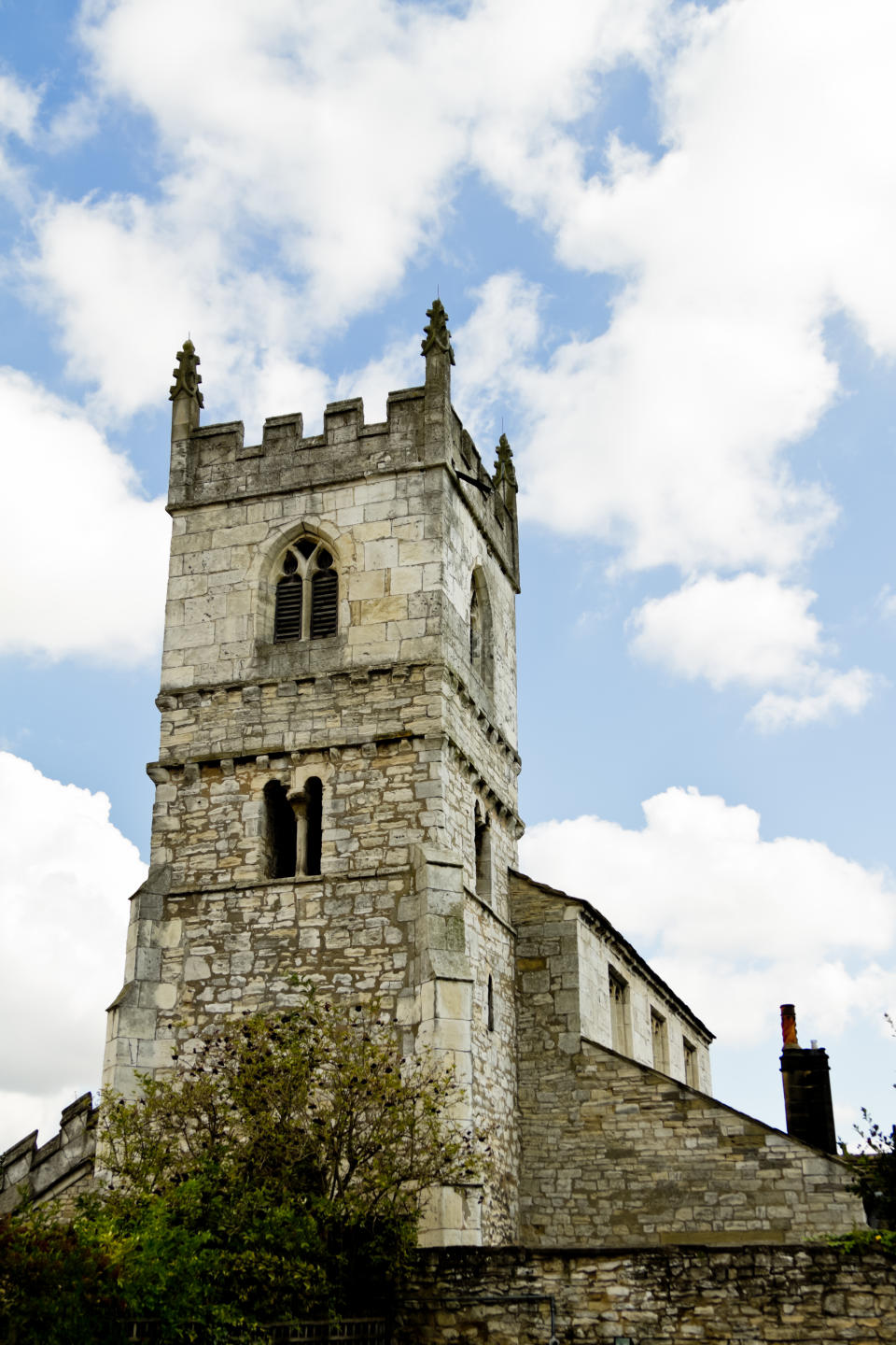 Ancient Gothic Castle of Monk Fryston in Yorkshire, northern England. Castle is under a pretty and dramatic mostly sunny sky.