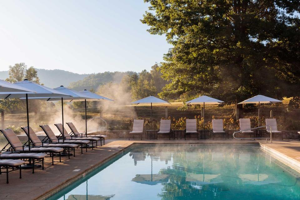 A pool, lounge chairs, and umbrellas at Blackberry Farm