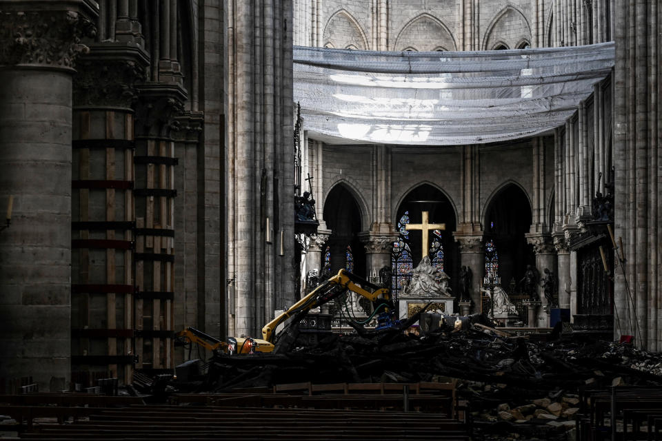 Rubble and the cross are pictured under a protective net inside Notre Dame de Paris Cathedral, May 15, 2019 in Paris. (Photo: Philippe Lopez/Pool via AP)          