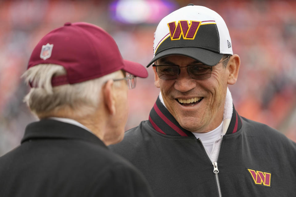 Washington Commanders head coach Ron Rivera, right, talking with former Washington Commanders head coach Joe Gibbs, left, during pregame warmups before the start of the first half of an NFL football game against the Dallas Cowboys, Sunday, Jan. 7, 2024, in Landover, Md. (AP Photo/Mark Schiefelbein)